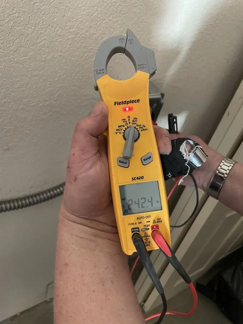 Voltage testing with clamp meter during Outlet Installation in West Lake Hills
